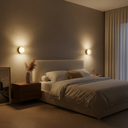 Cozy bedroom with a bed, nightstands, and wall lights.